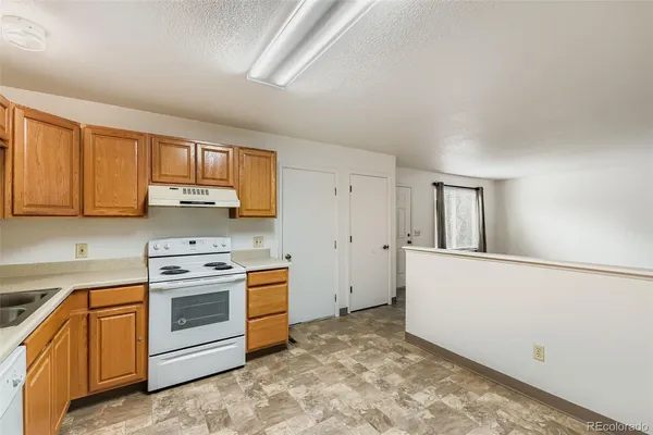 a kitchen with a stove top oven and cabinets
