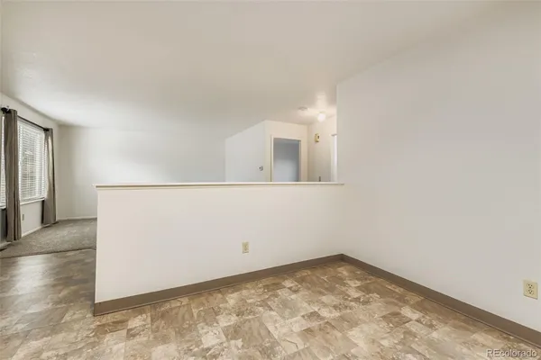 an empty room with an entrance to other room