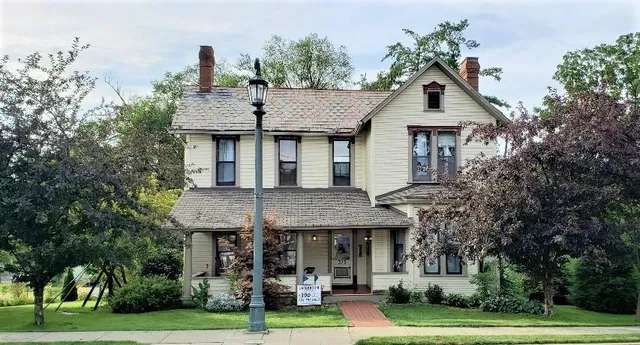 a front view of a house with a garden