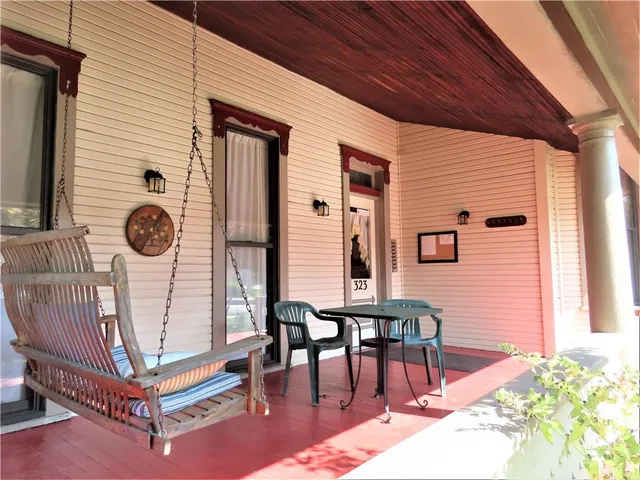 a front view of a house with outdoor seating