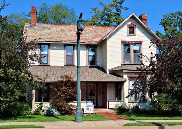 a front view of a house with a garden