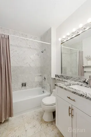 a kitchen with granite countertop white cabinets and white appliances