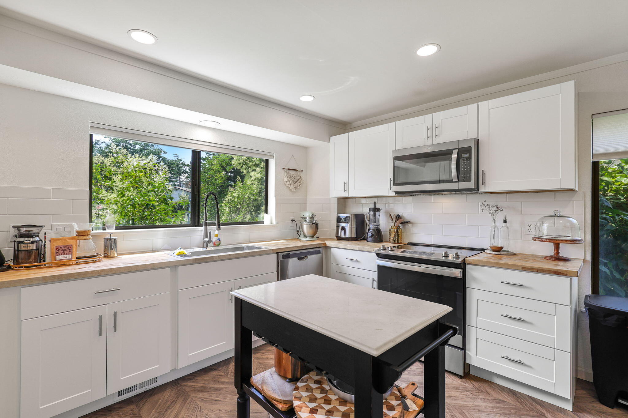 3718 Cal Ore Drive Redding, CA 96001 - Photo 8 of 28 a kitchen with a stove a sink a microwave a window and cabinets