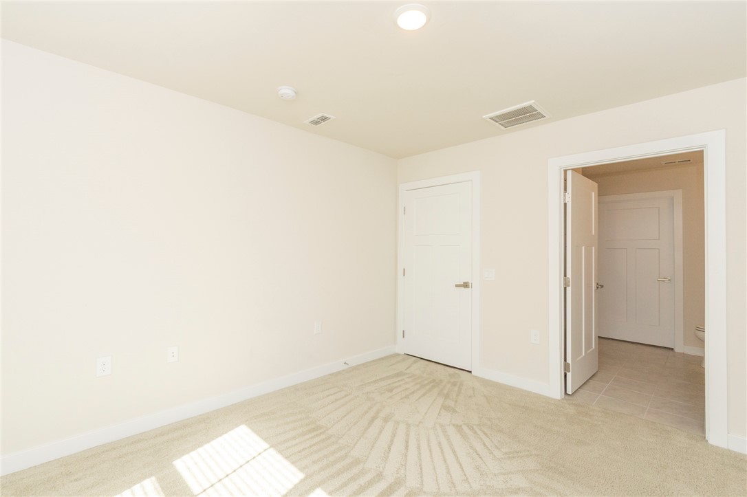 233 Scenic Road Anderson, SC 29621 - Photo 28 of 50 A well-lit bedroom features plush carpet flooring and clean, modern doors.