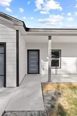 a view of kitchen with stove and cabinets