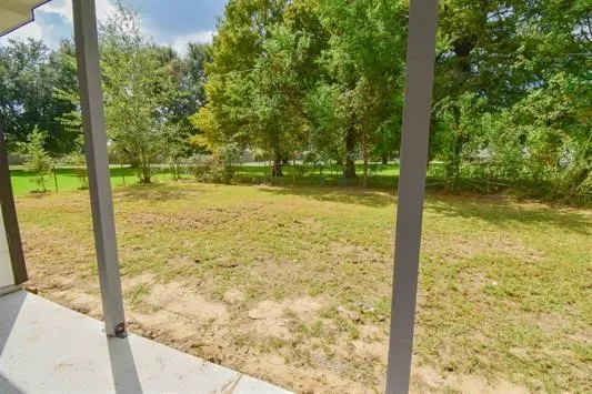 a view of a yard with a tree