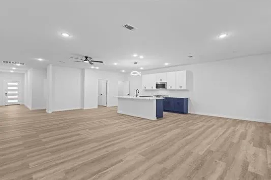 a view of kitchen center sink and cabinets