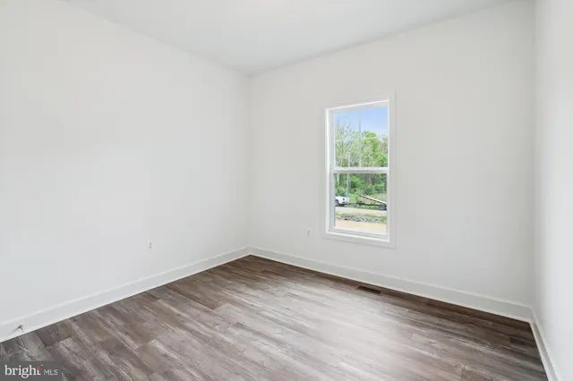 wooden floor in a hall with an empty room