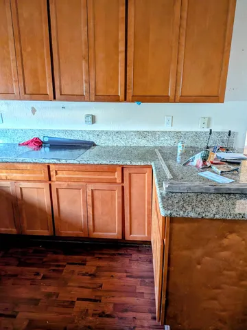 a kitchen with granite countertop cabinets and sink