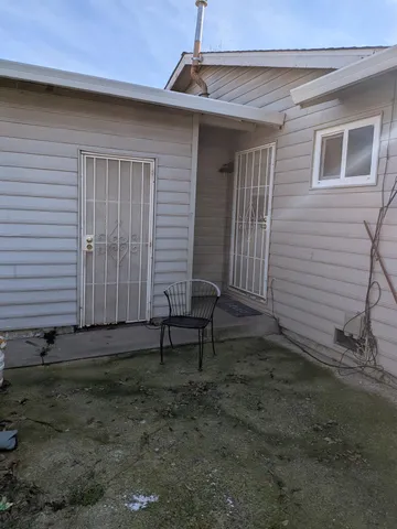 a view of a house with backyard and wooden fence