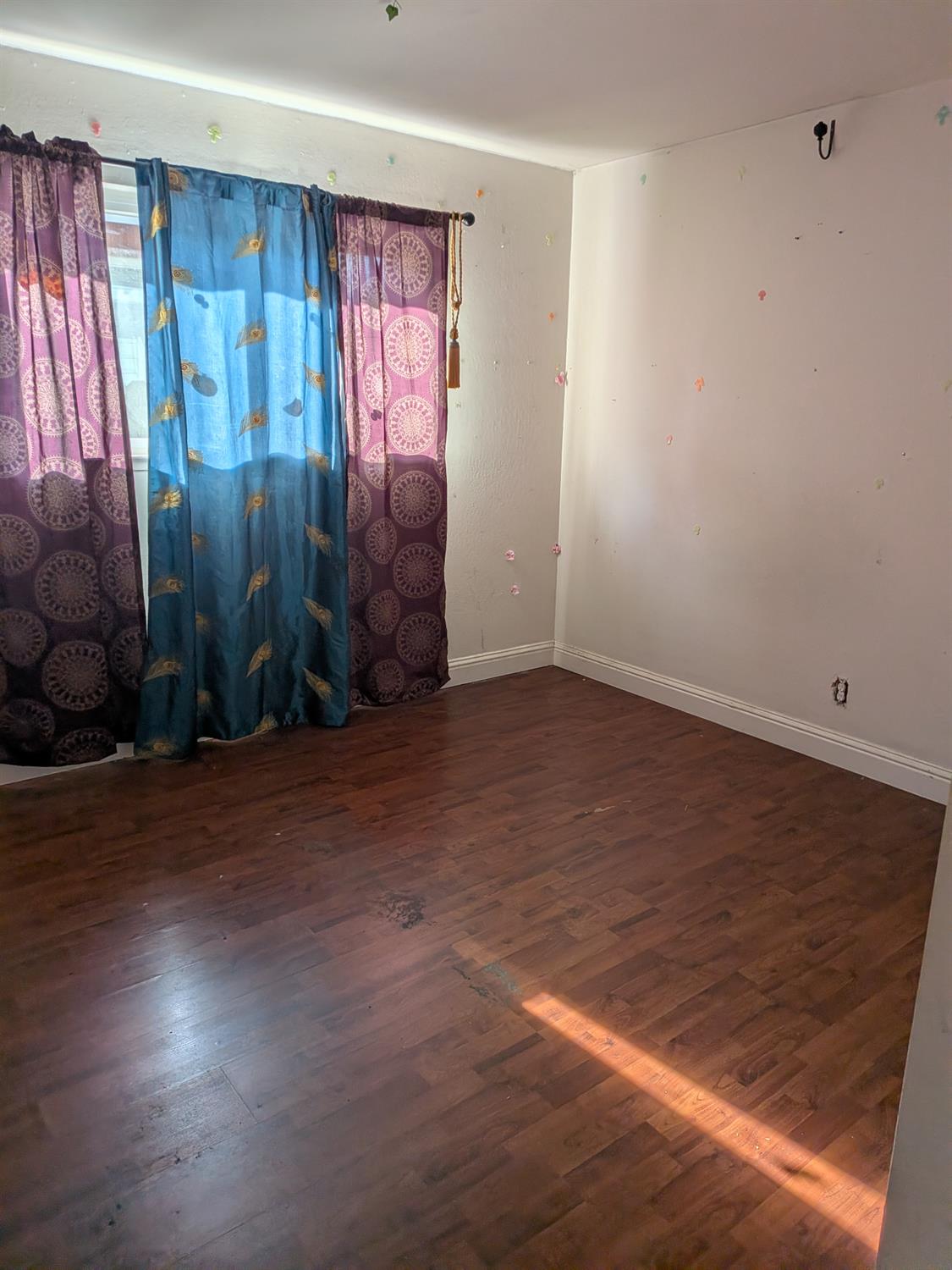 10517 Mills Acres Circle Rancho Cordova, CA 95670 - Photo 8 of 19 an empty room with wooden floor and window