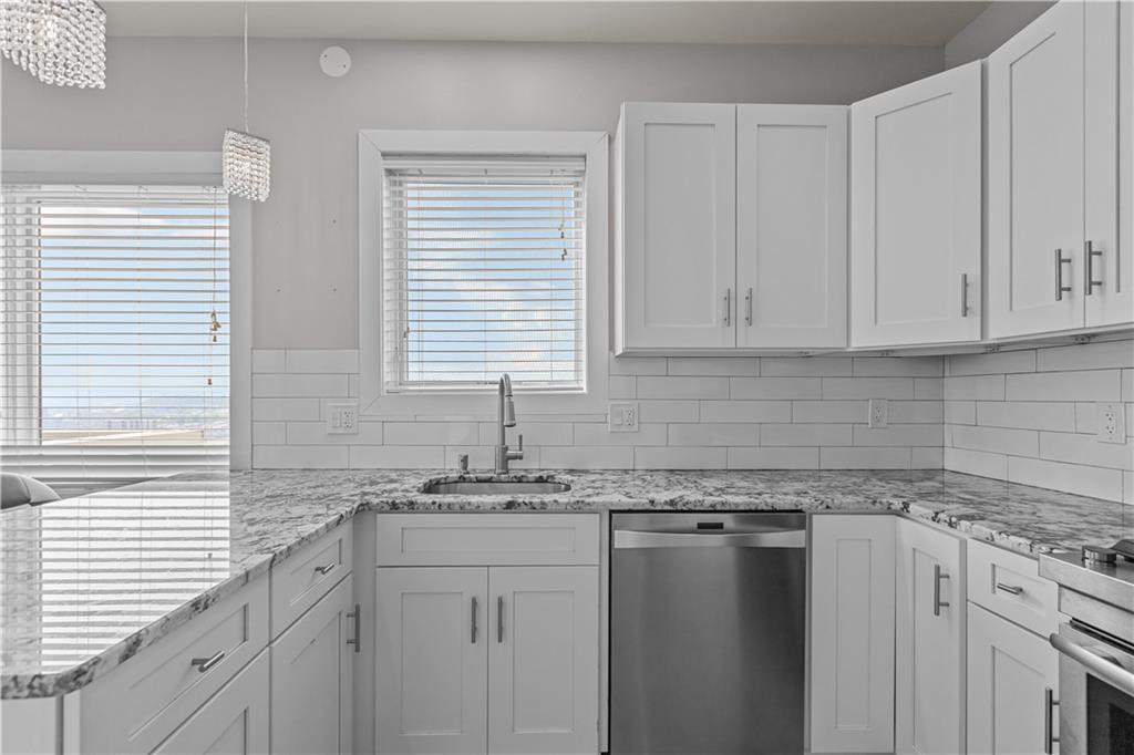 1825 Arcena Street, Unit 3 Pittsburgh, PA 15219 - Photo 12 of 31 a kitchen with granite countertop cabinets sink and window