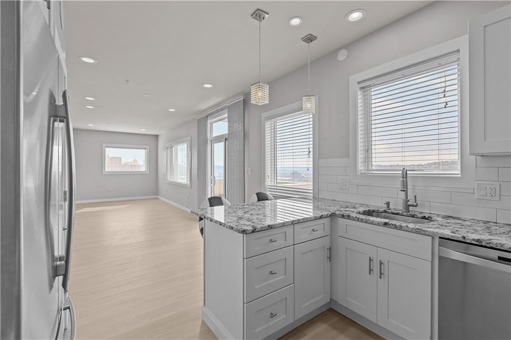 1825 Arcena Street, Unit 3 Pittsburgh, PA 15219 - Photo 13 of 31 a spacious bathroom with a granite countertop sink mirror and a shower