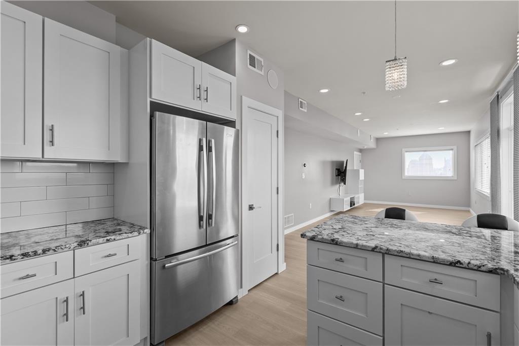 1825 Arcena Street, Unit 3 Pittsburgh, PA 15219 - Photo 14 of 31 a kitchen with granite countertop cabinets appliances and a counter space