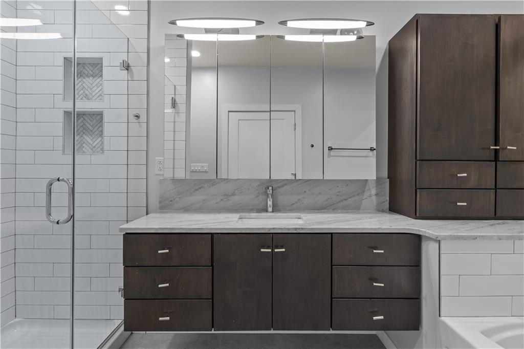1825 Arcena Street, Unit 3 Pittsburgh, PA 15219 - Photo 23 of 31 a bathroom with a granite countertop sink and a mirror