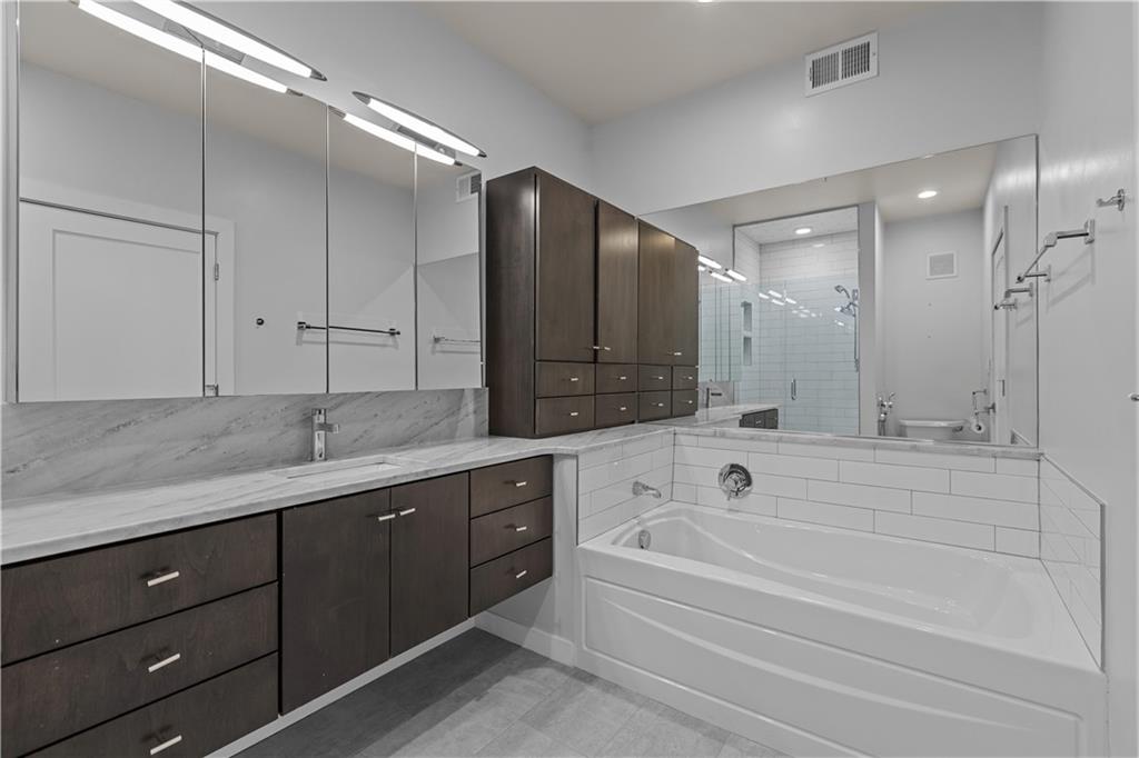 1825 Arcena Street, Unit 3 Pittsburgh, PA 15219 - Photo 24 of 31 a spacious bathroom with a tub sink shower and mirror