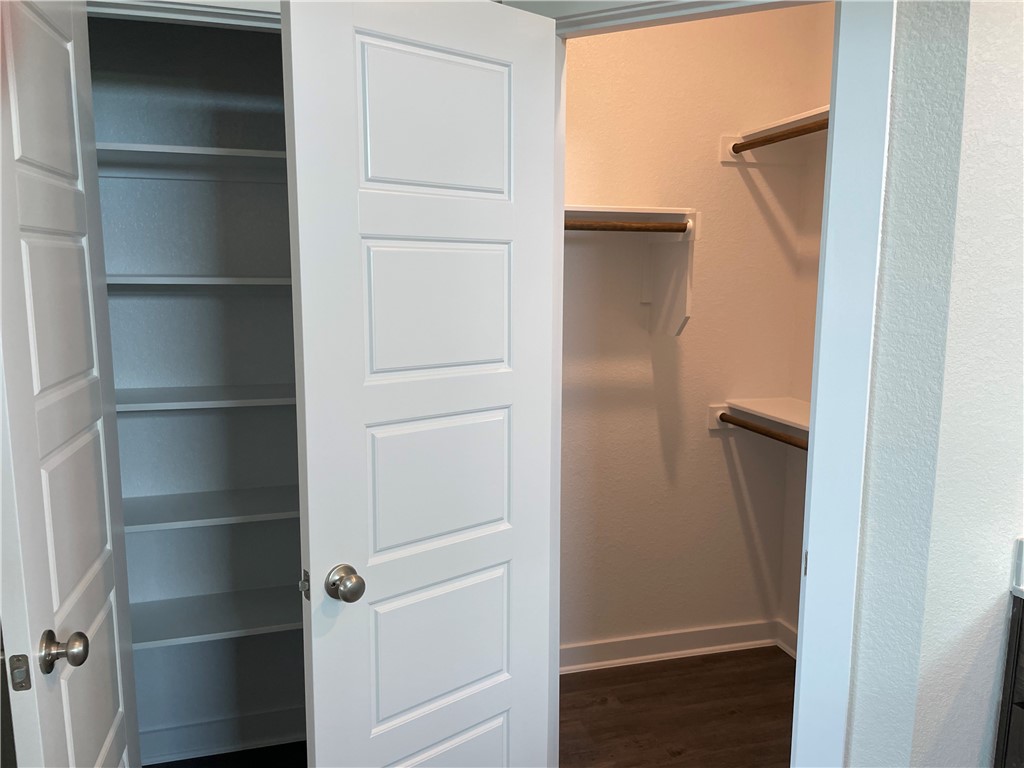 609 Paddock Lane Georgetown, TX 78626 - Photo 14 of 40 Ample built-in shelving and hanging rods maximize efficiency inside this modern closet space.