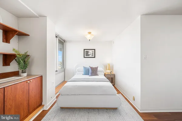 a bed room with a bed and a painting