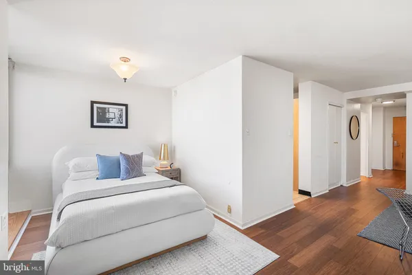 a bedroom with a bed and a painting on the wall