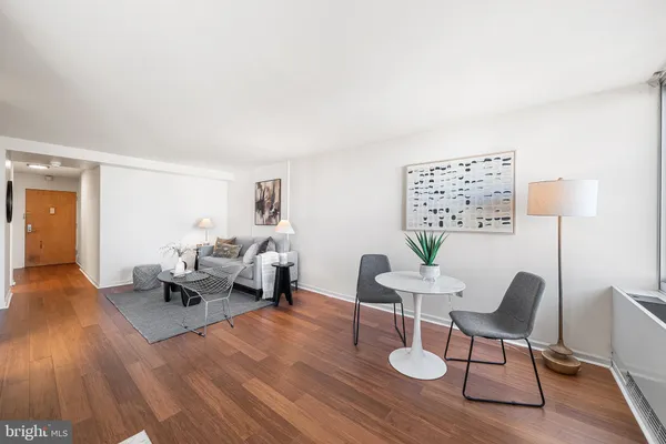 a living room with furniture and wooden floor