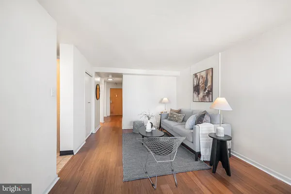 a living room with furniture and a wooden floor
