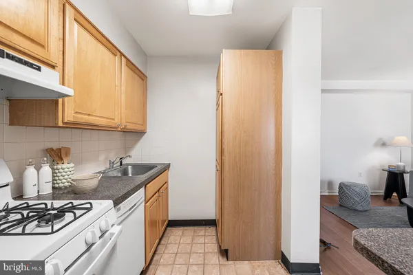 a kitchen with stainless steel appliances granite countertop a stove and a refrigerator