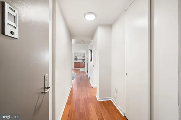 a view of a hallway with wooden floor