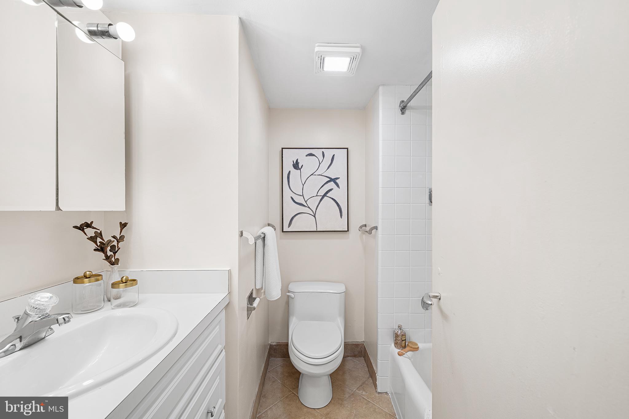 604 South Washington Square, Unit 2606 Philadelphia, PA 19106 - Photo 24 of 37 a bathroom with a sink a toilet and a mirror