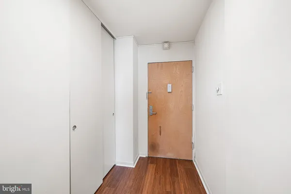 a view of a hallway with wooden floor