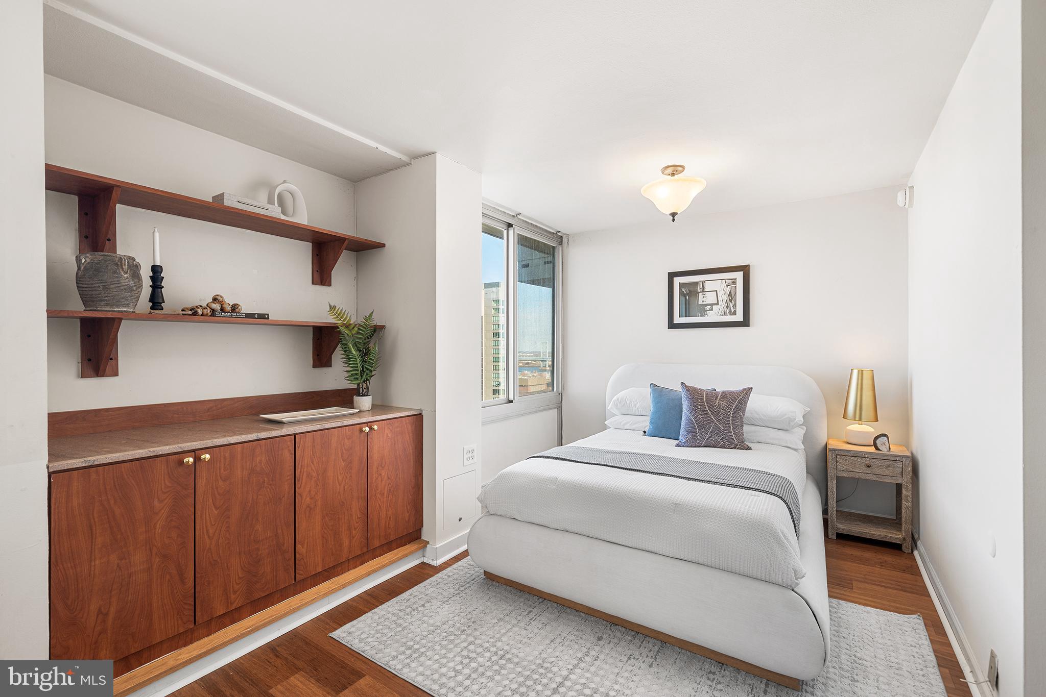 604 South Washington Square, Unit 2606 Philadelphia, PA 19106 - Photo 10 of 37 a bedroom with a bed and a cabinets