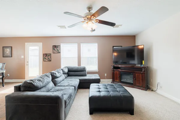 a living room with furniture and a flat screen tv