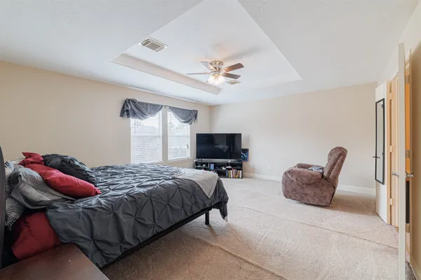 a bedroom with furniture and a flat screen tv