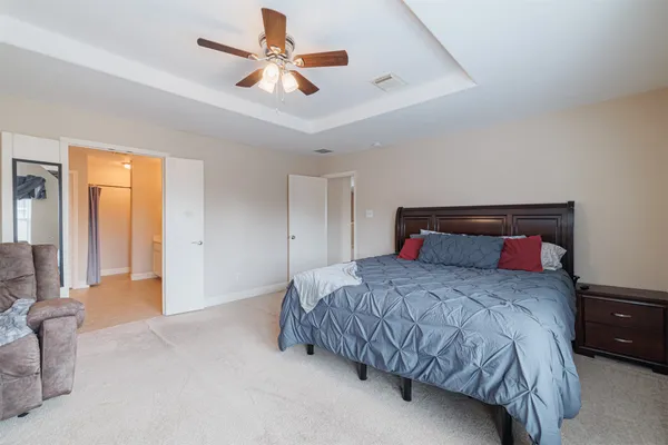 a bedroom with a bed and a chandelier