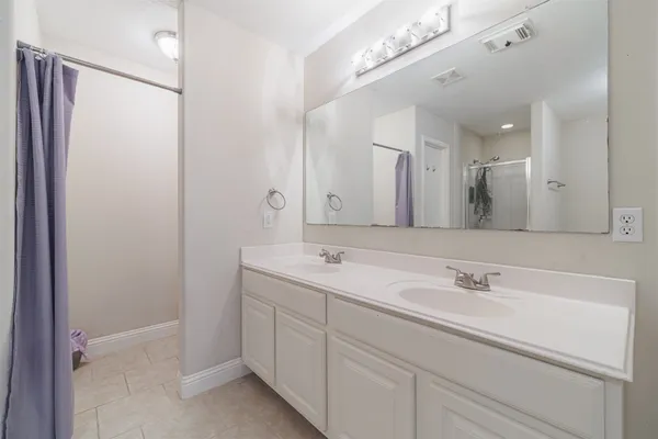a bathroom with a double vanity sink mirror and