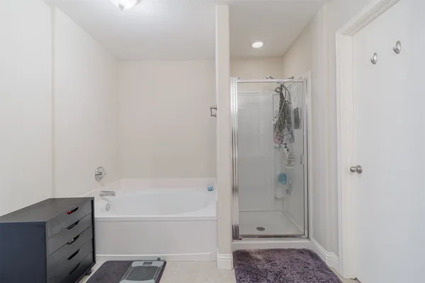 a bathroom with a bathtub and a shower