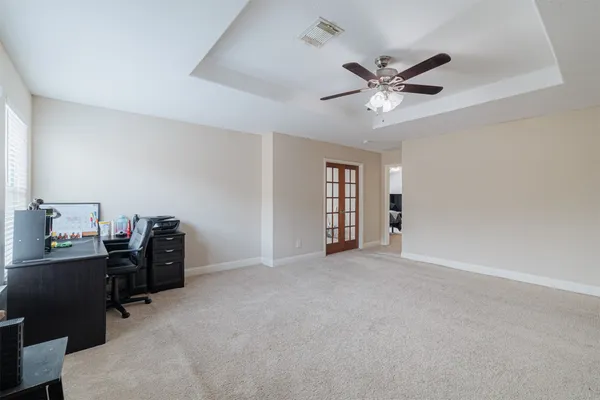 a view of a workspace with furniture and a window
