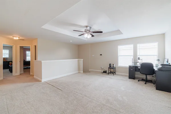 a view of a livingroom with workspace and a window