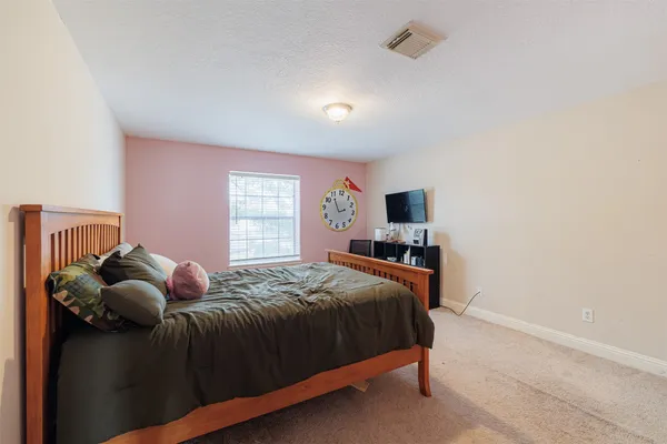 a bedroom with a bed and window