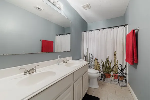 a bathroom with a sink double vanity and mirror