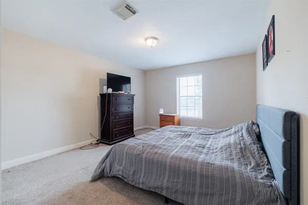 a bedroom with a bed and a television