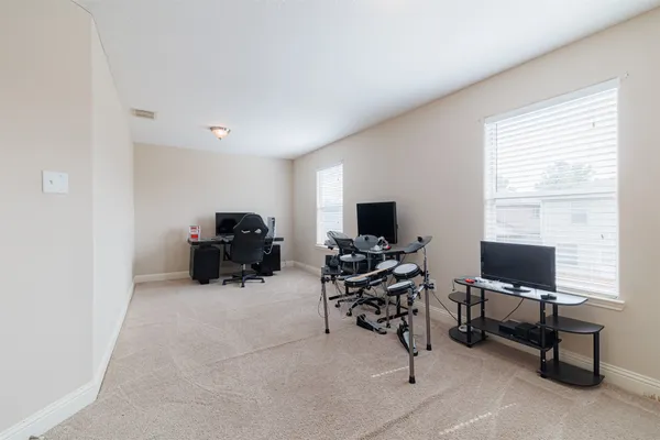 a view of a livingroom with workspace and a window