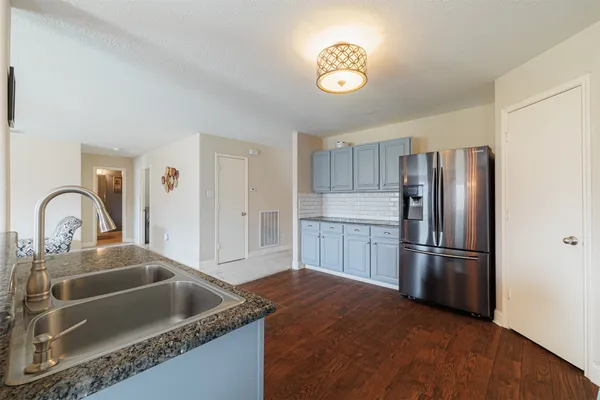 a kitchen with kitchen island a counter top and stainless steel appliances