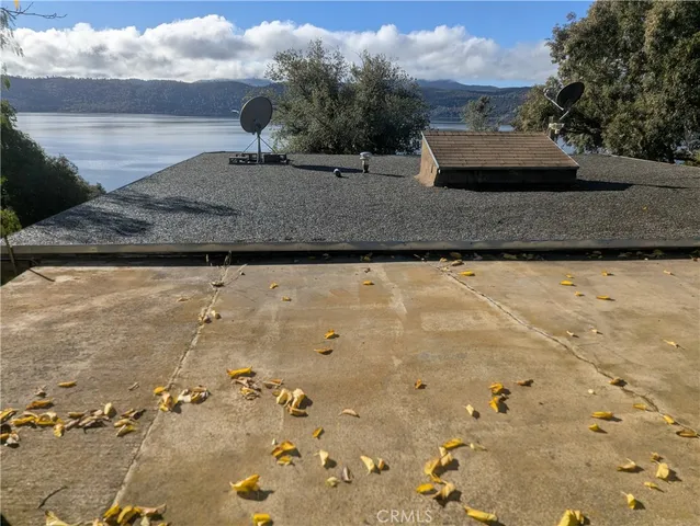 a view of a dry yard with wooden fence