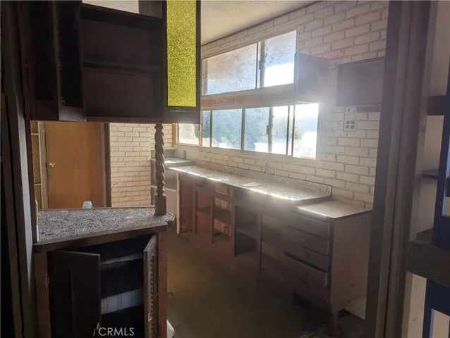 a view of kitchen with granite countertop window