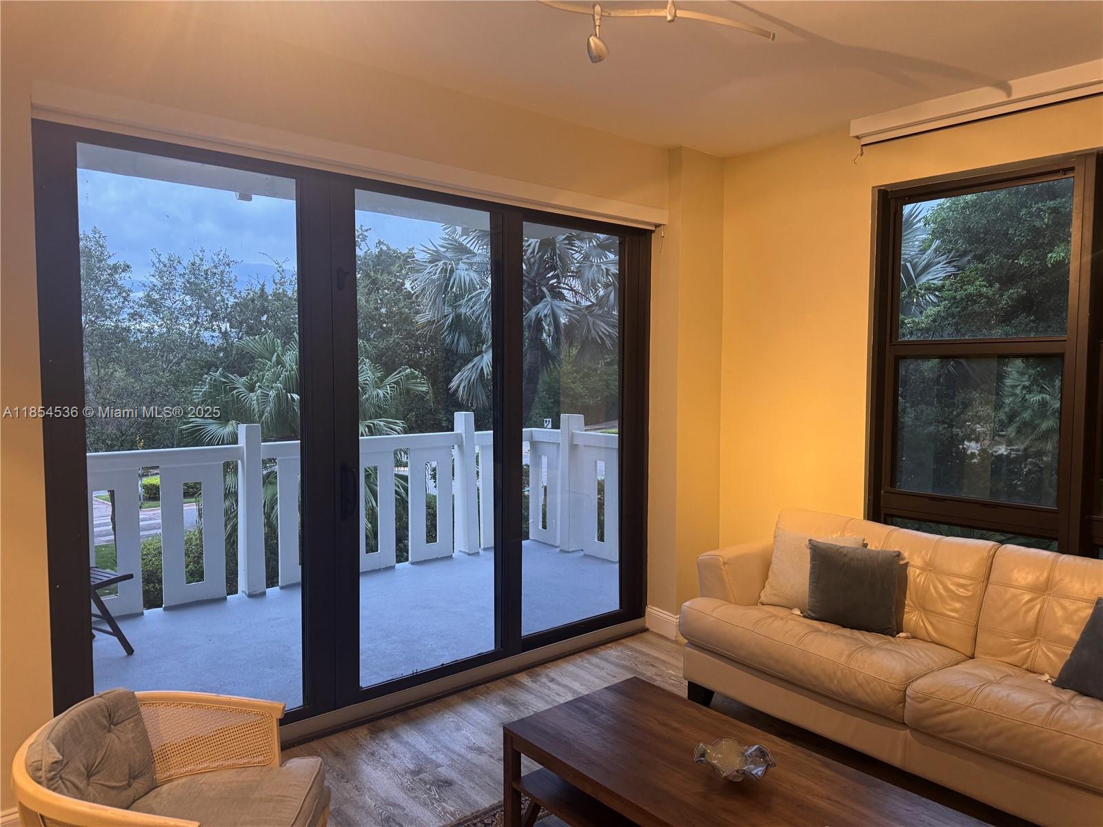1121 Crandon Boulevard, Unit E108 Key Biscayne, FL 33149 - Photo 11 of 54 a living room with furniture and a large window