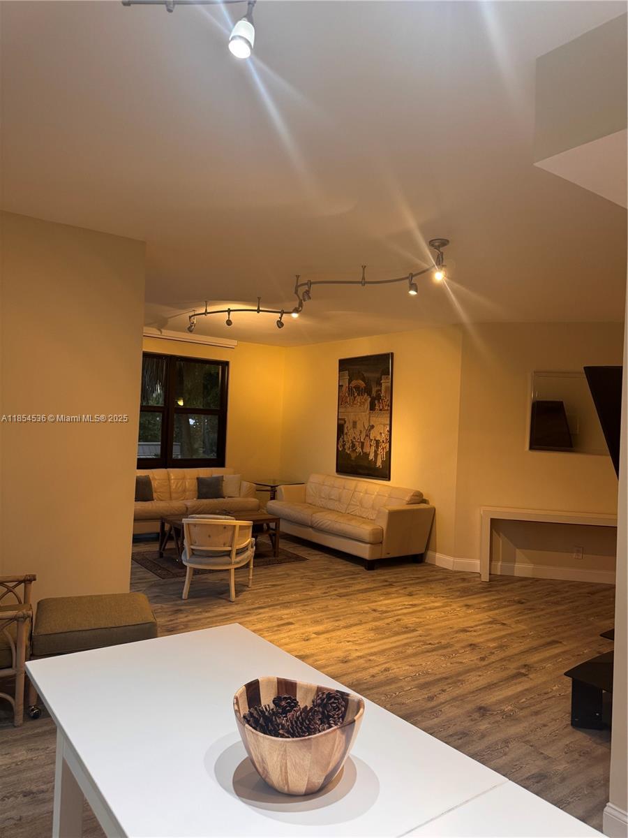 1121 Crandon Boulevard, Unit E108 Key Biscayne, FL 33149 - Photo 12 of 54 a living room with furniture and a wooden floor