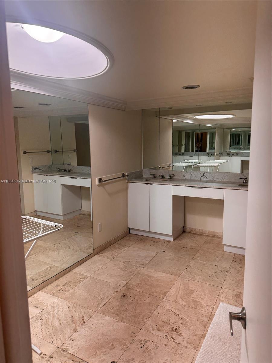 1121 Crandon Boulevard, Unit E108 Key Biscayne, FL 33149 - Photo 32 of 54 a kitchen with stainless steel appliances a sink and cabinets