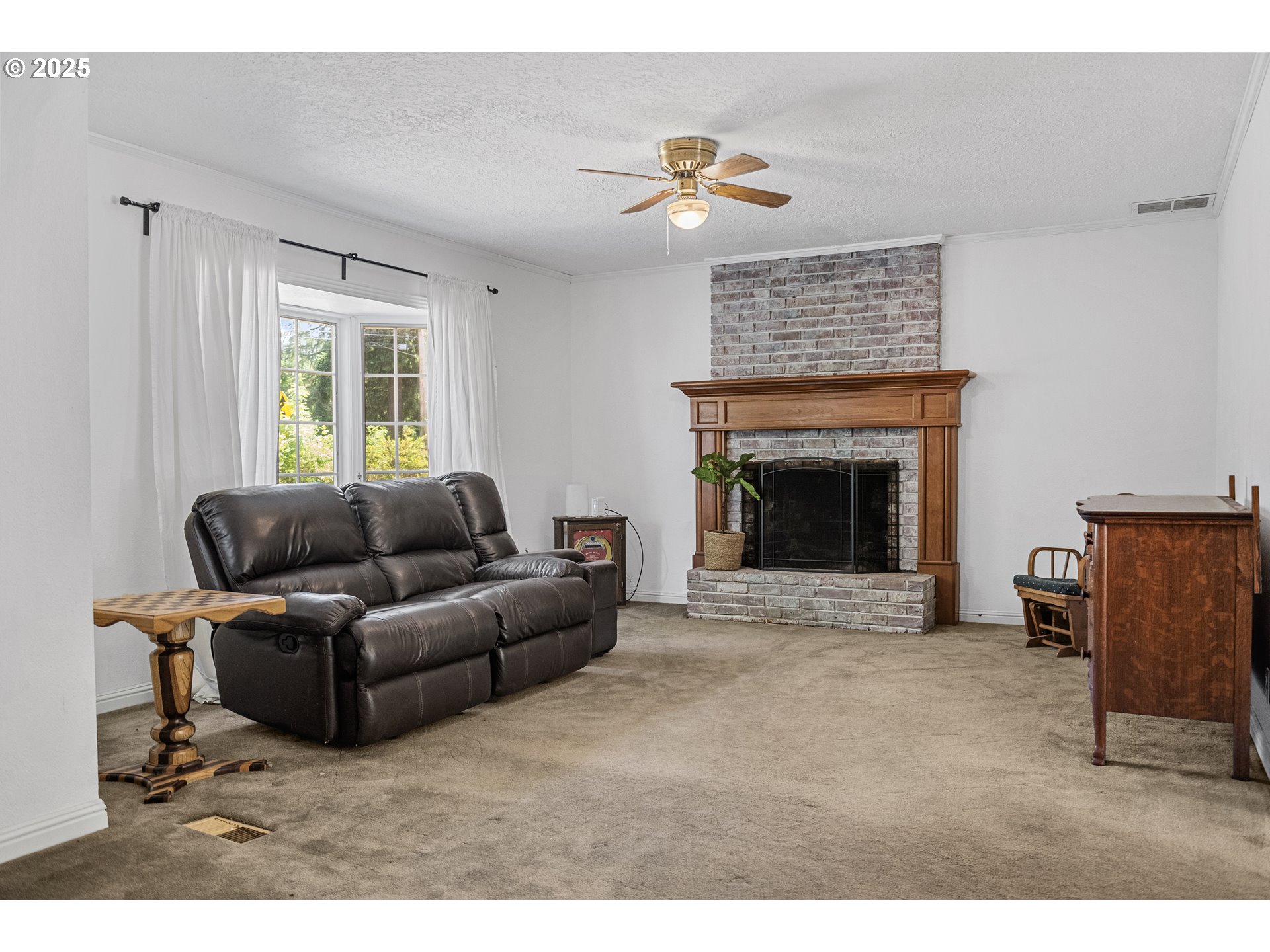 15317 South Hattan Road Oregon City, OR 97045 - Photo 5 of 44 a living room with furniture and a fireplace