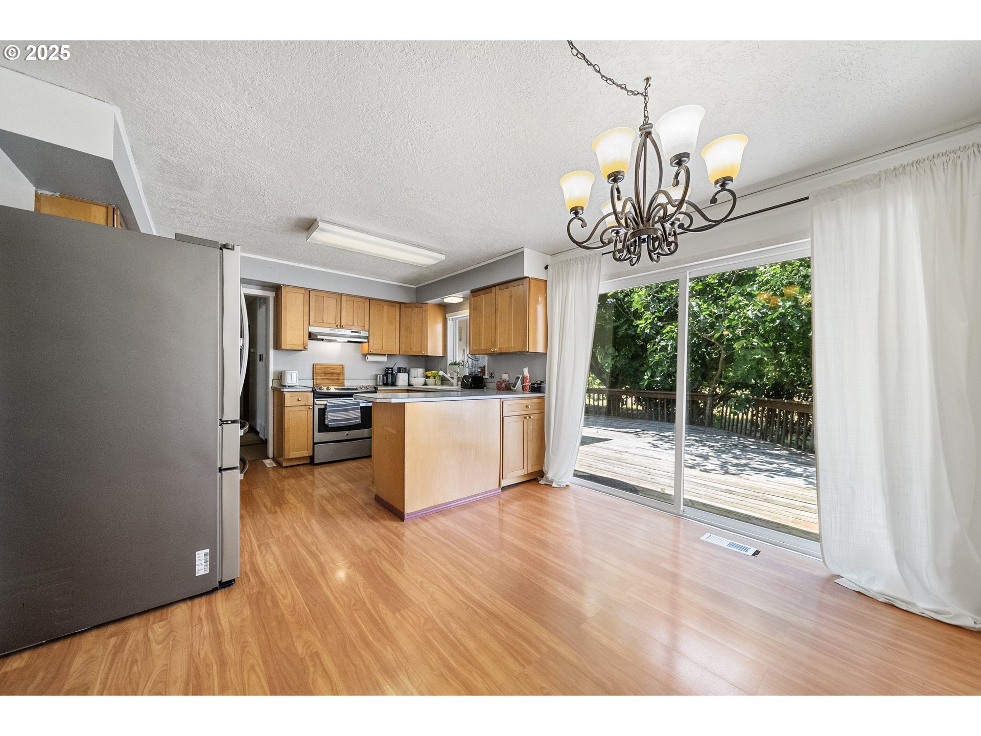 15317 South Hattan Road Oregon City, OR 97045 - Photo 7 of 44 a view of a kitchen and dining room