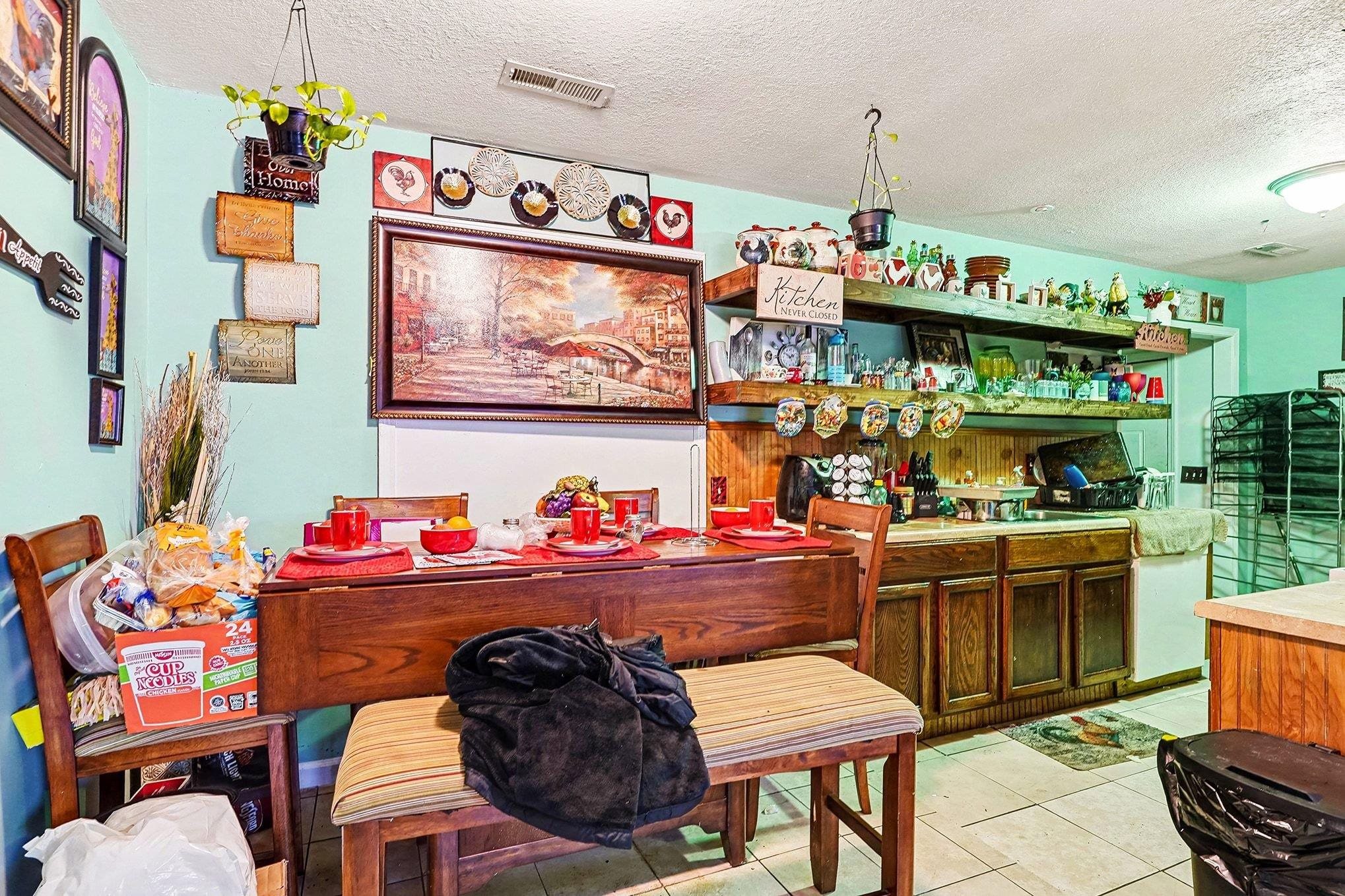 2849 Highway 545 Conway, SC 29526 - Photo 18 of 34 Indoor bar featuring a textured ceiling, light tile patterned floors, light countertops, white dishwasher, and brown cabinets